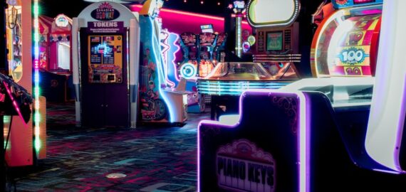 a room filled with arcade machines and neon lights